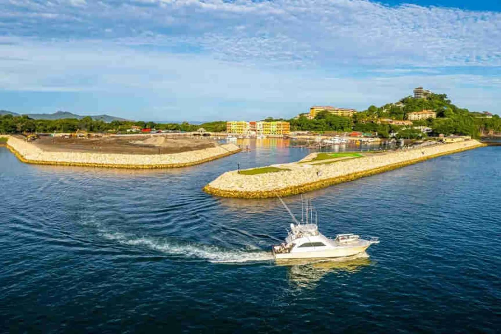 Sportfishing charter boat heading out through the Flamingo Marina channel toward the Pacific, Guanacaste, Costa Rica
