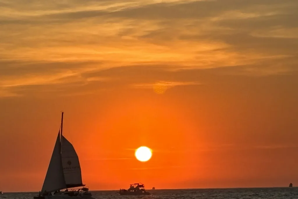 Blazing orange sunset over the water at the north end of Playa Potrero beach, Guanacaste, Costa Rica