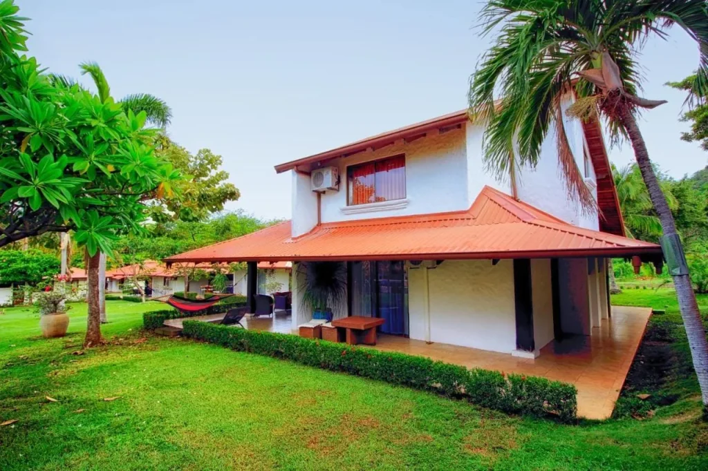 A private terracotta-roofed villa with a garden and hammock at Villas Estival on Playa Prieta, Playa Potrero