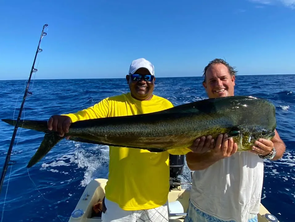 Two anglers holding a large mahi-mahi caught aboard a Boomerang fishing charter in Guanacaste, Costa Rica