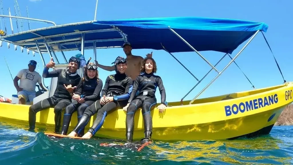 Snorkelers in wetsuits aboard the Boomerang before a snorkeling trip off Playa Potrero, Costa Rica