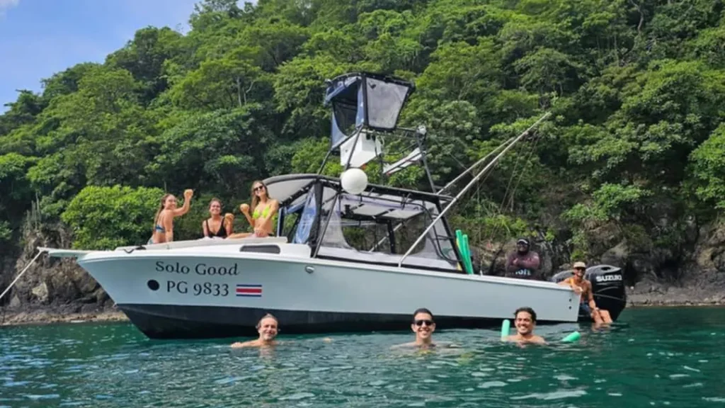 The Solo Good anchored in a cove near Playa Potrero, Costa Rica, with guests relaxing aboard and in the water