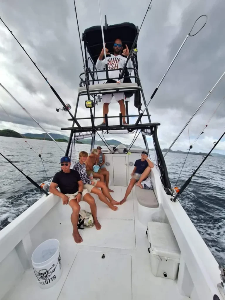 Guests and captain aboard the Solo Good sport fishing charter off Playa Potrero, Costa Rica, fishing rods rigged